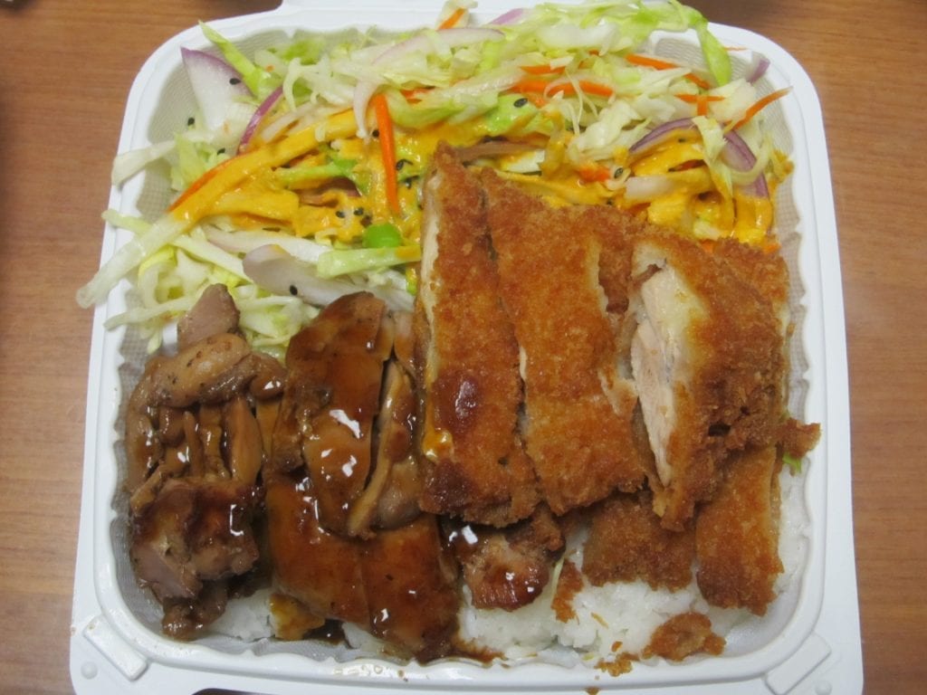 Plate with Chicken Katsu and green salad over rice